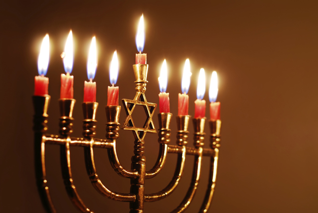 A Hanukkah menorah with all candles lit.